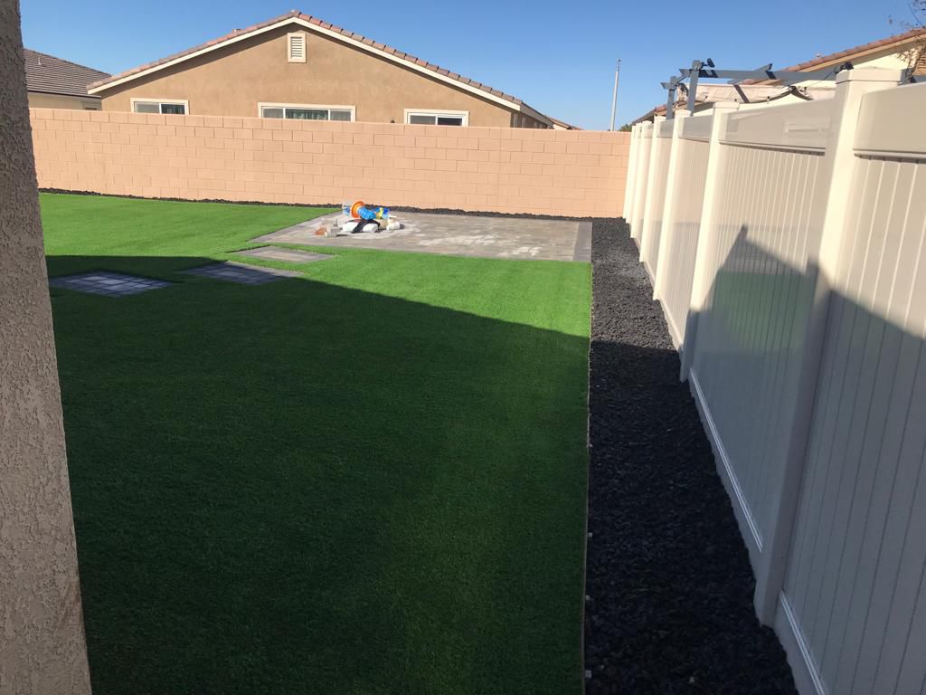 Backyard Artificial Turf With Lava Rock Border