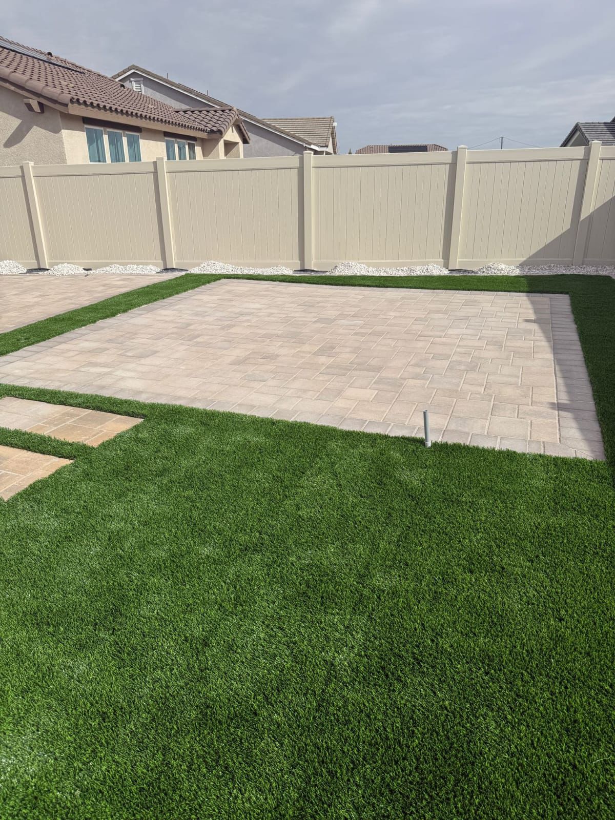 Paver Patio Surrounded by Turf and Gravel