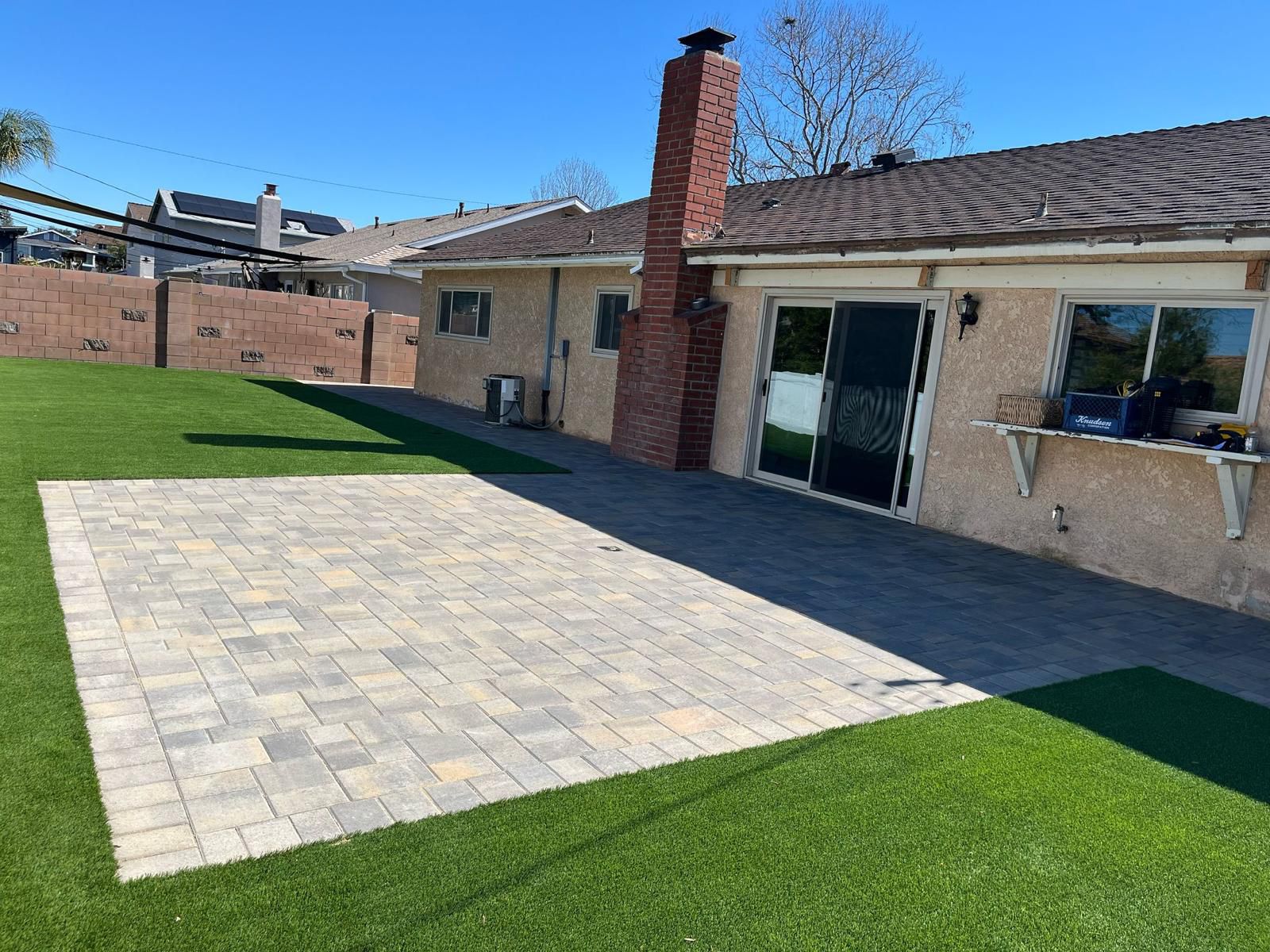 Ranch Home Paver Patio With Turf Lawn