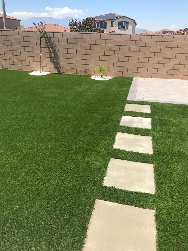 Turf Backyard With Stepping Stones and Mountain View